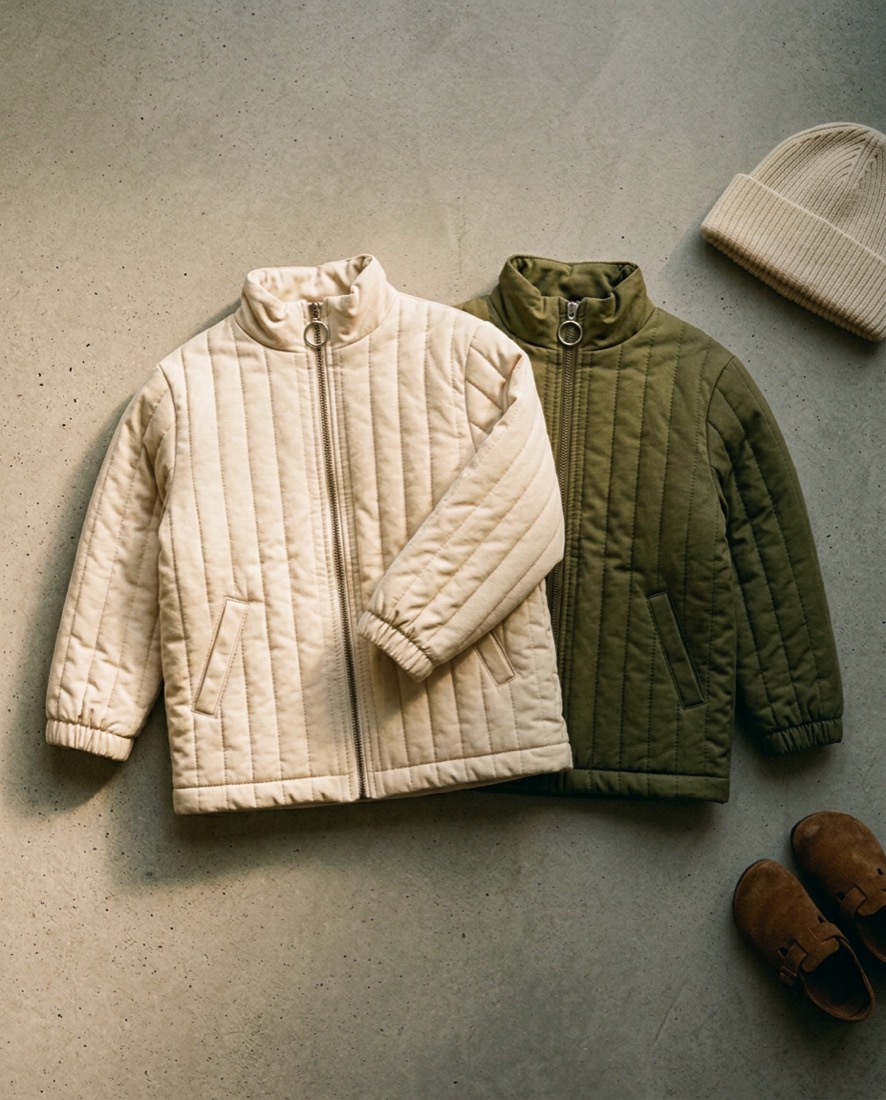 Two quilted puffers, undyed cream over olive, on concrete